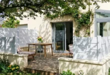 clôture blanche originale posée sur une murette enduit autour d'un terrasse en bois