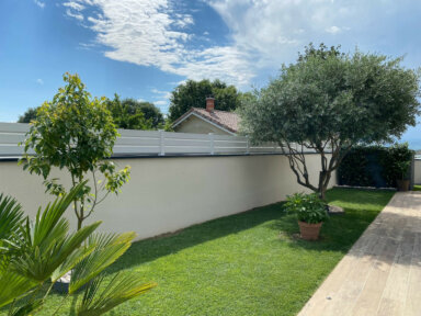 Clôture en pvc blanc brise-vue en bord de jardin sur muret pour maison de lotissement