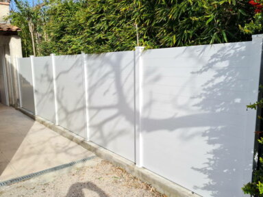 Clôture en pvc blanc brise-vue sur muret pour aménager votre extérieur