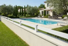 Clôture à une seule lame installée sur une muret enduit autour d'une piscine